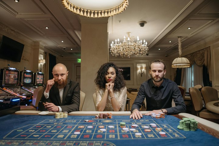 Poker players competing at a crowded tournament table.